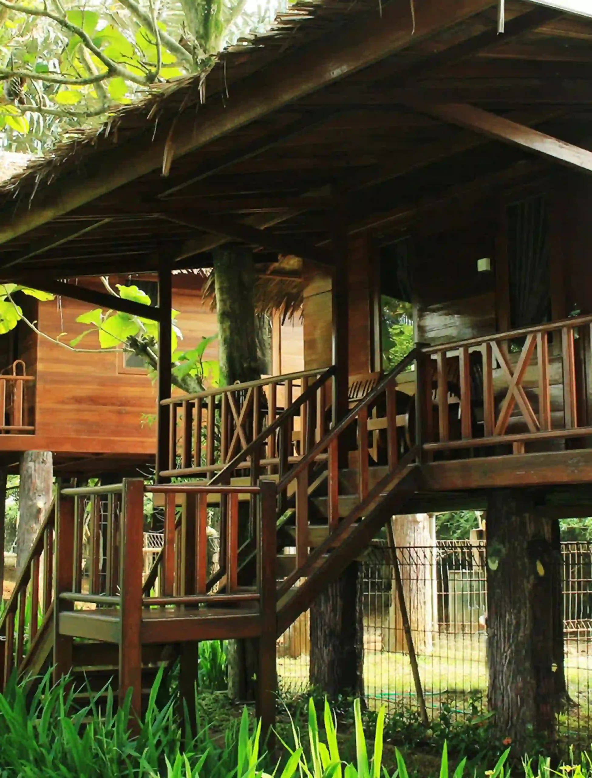 a tree house with a roof and stairs The Highland Park Resort Bogor